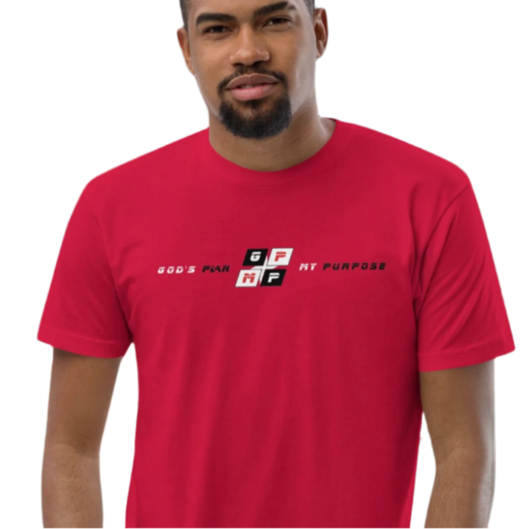 Red Heat Tee in vibrant red worn by a person against a geometric red and black background.