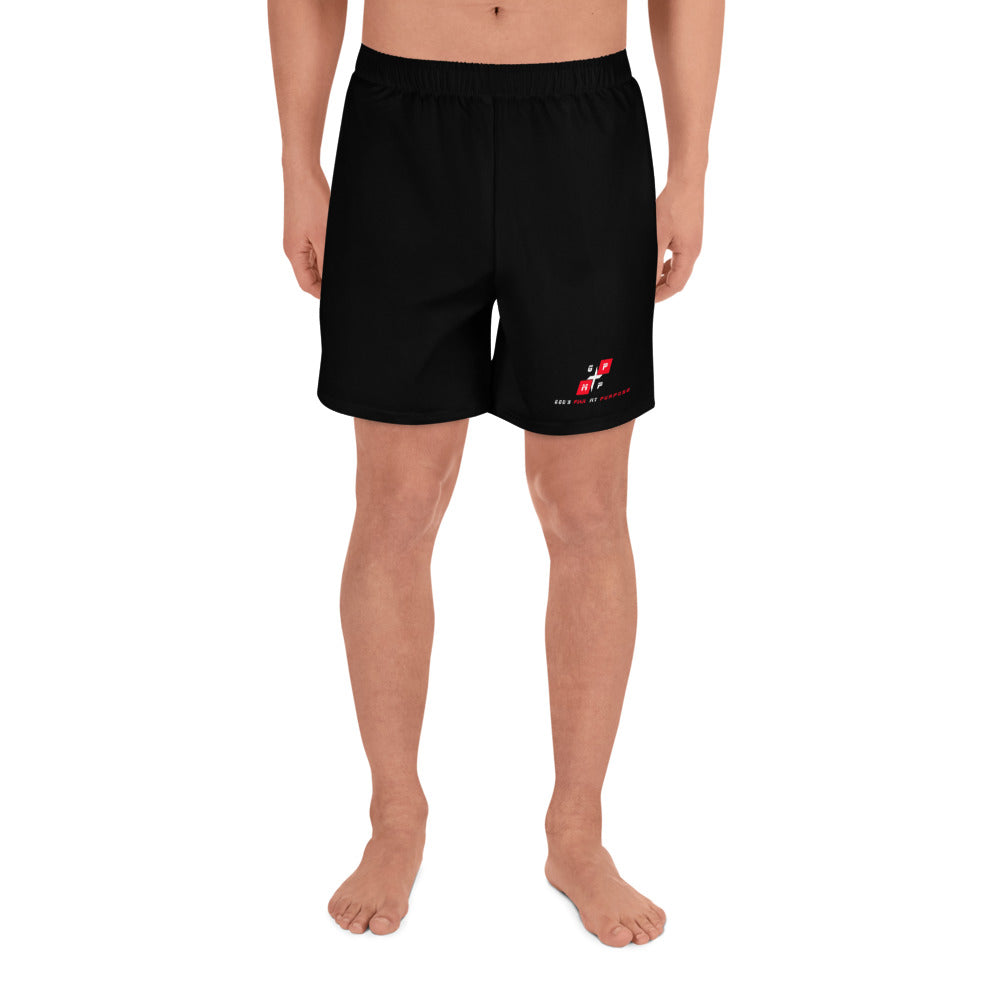 All-Over Print Unisex Athletic Long Shorts in black, featuring recycled polyester and spandex blend, shown on a person.