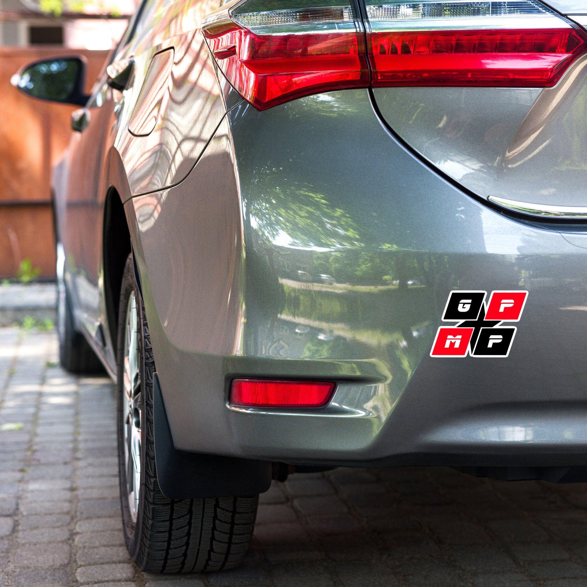 GPMP 5.5 x 5.5 inch vinyl sticker on car bumper, durable high-opacity adhesive.