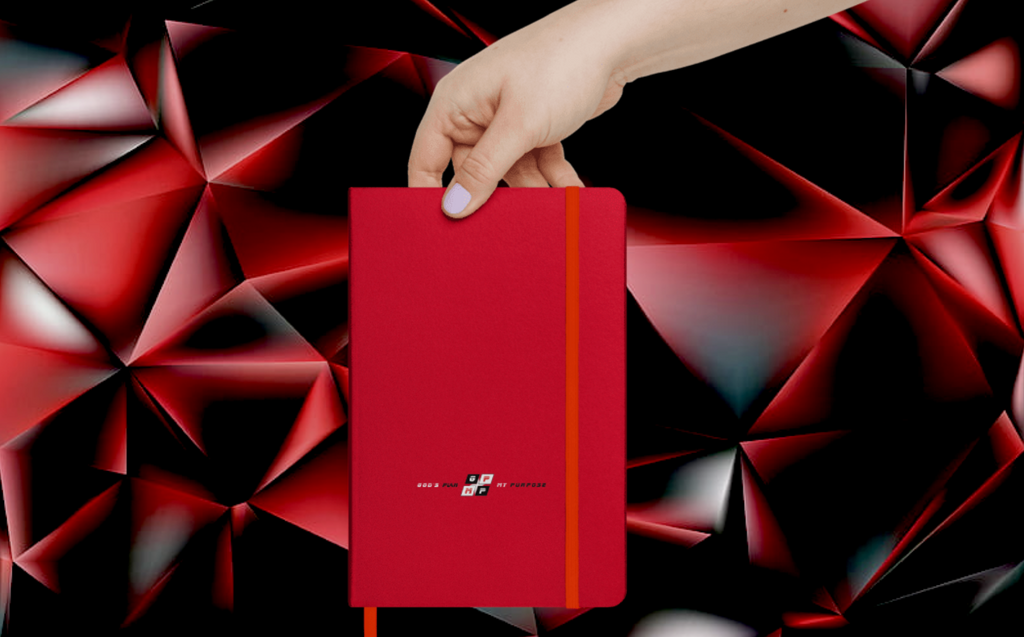 Red Heat Journal with UltraHyde cover and elastic closure, held against a red geometric background.