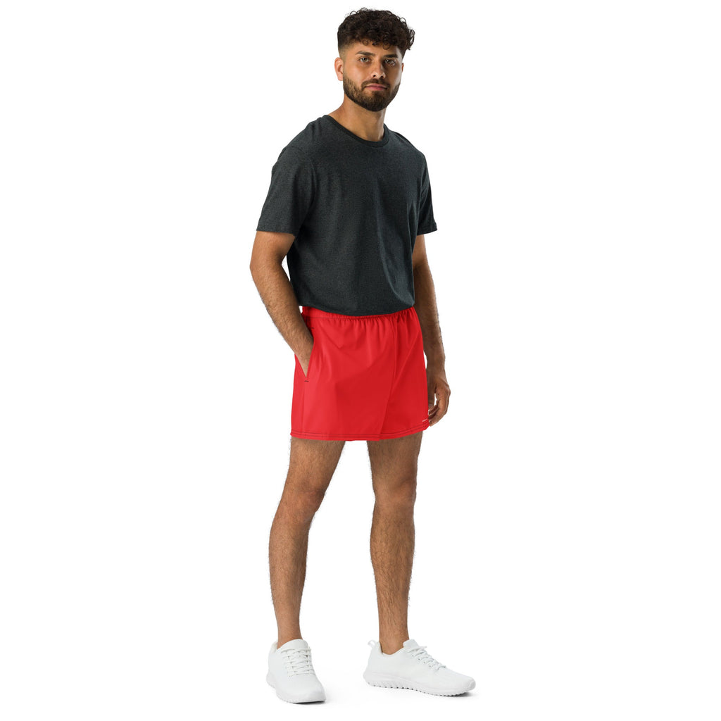 Man wearing GPMP Red Athletic Shorts with pockets, suitable for sports and swimming, featuring a comfortable fit and moisture-wicking fabric.